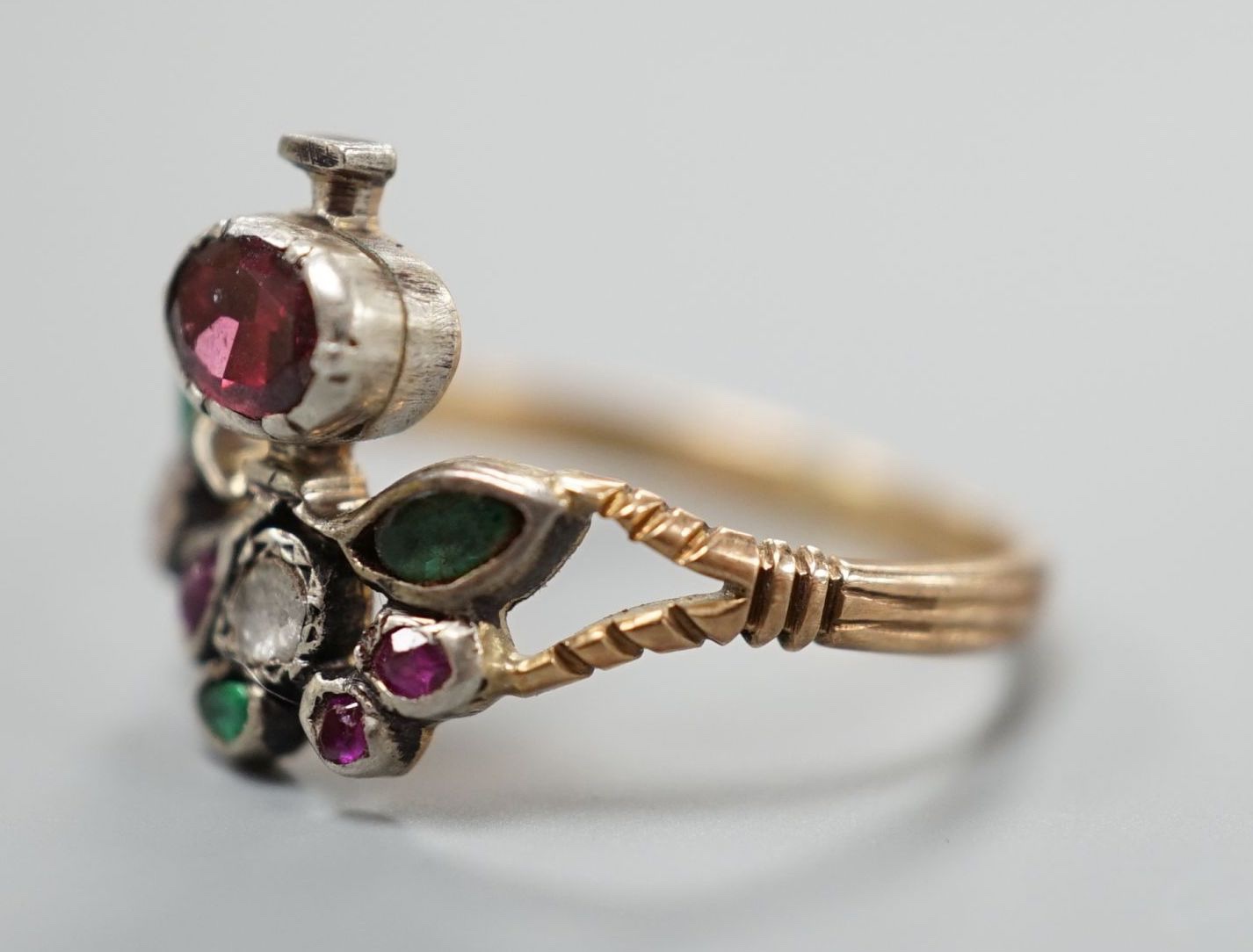 An early 20th century continental? Arts & Crafts yellow metal and multi gem set cluster ring, size P, gross weight 2.4 grams.